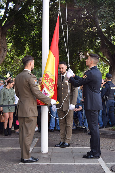 Agentes de la Policía Nacional izando la Bandera de España. 